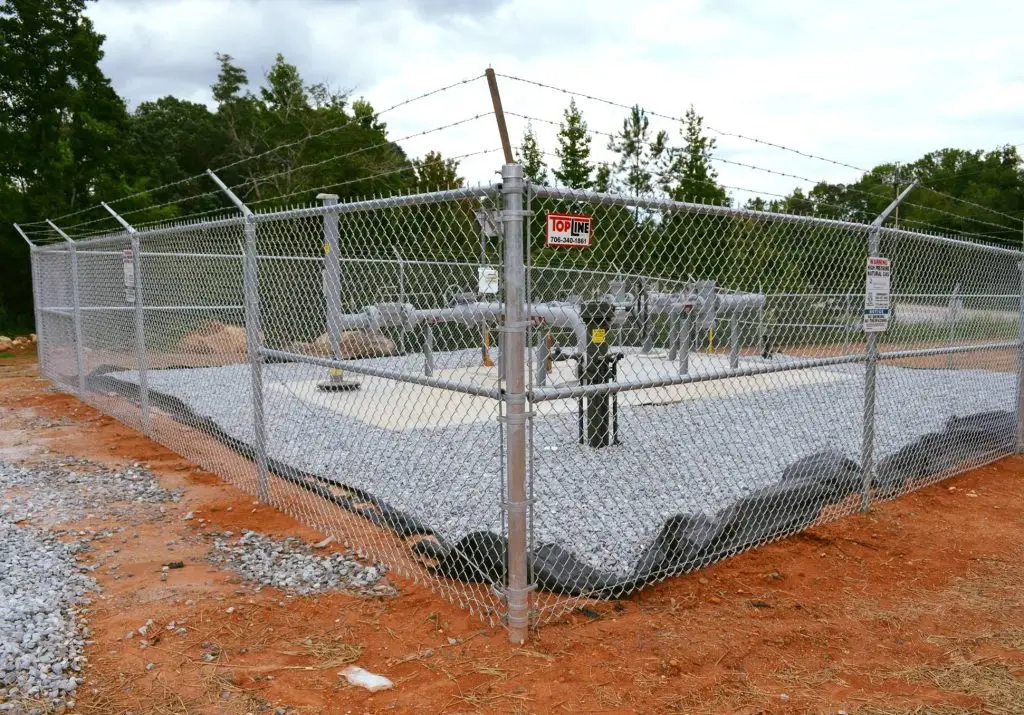 Chainlink fence with barbed wire top